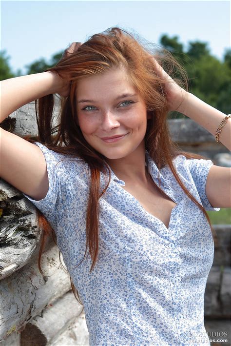 sexy redhead unbuttons her shirt to reveal her perky small