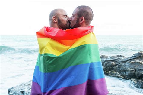 lgbt pride concept gay couple embracing lovingly wrapped in the