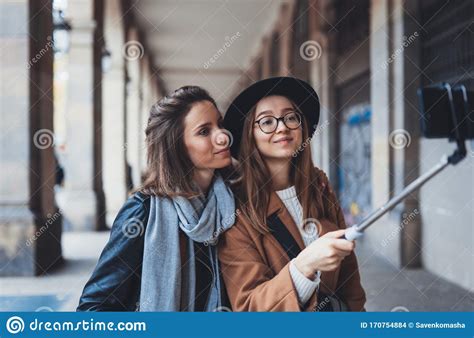 smile girlfriends taking photo selfie on smartphone mobile blogger