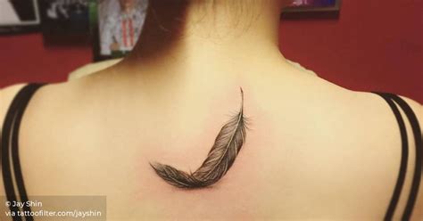 Feather Tattoo On The Upper Back