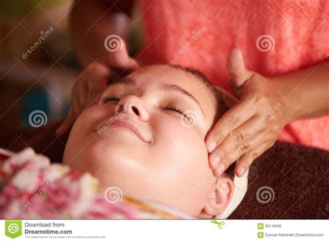 teen girl getting a massage during her facial at the spa stock image