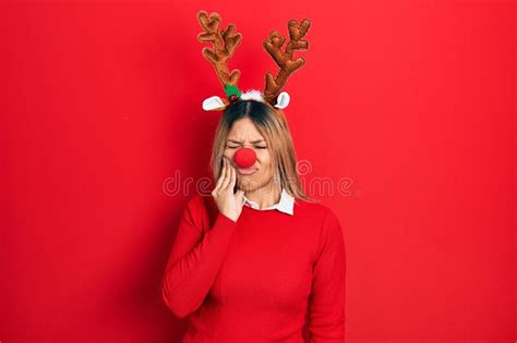 Beautiful Hispanic Woman Wearing Deer Christmas Hat And Red Nose