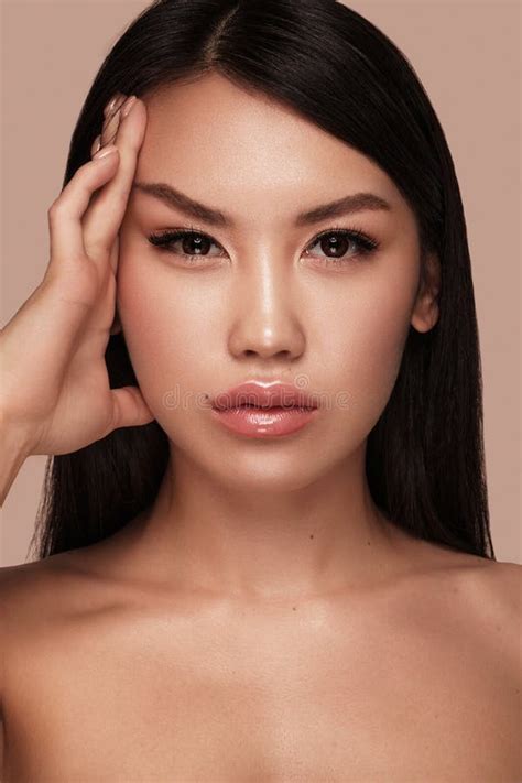 Beautiful Delicate Woman Of Oriental Type With Nude Makeup And Perfect