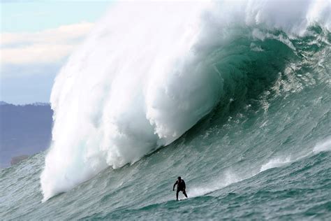 giant waves lure surfers  france sbs news