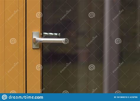 Close Up Macro View Of Silver Door Handle Of Yellow Glass Door