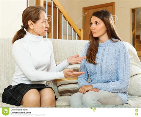 mother with teen daughter having serious talking stock