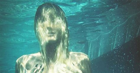 heidi klum poses topless underwater in series of sultry