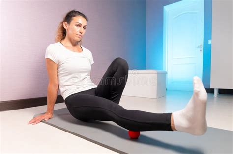 Sporty Slim Caucasian Woman Doing Self Massage On Fitness Mat With