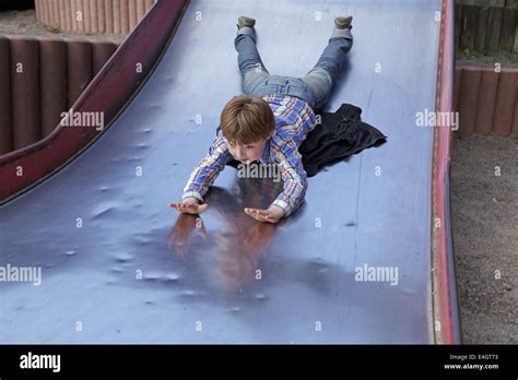 young boy sliding      belly stock photo alamy