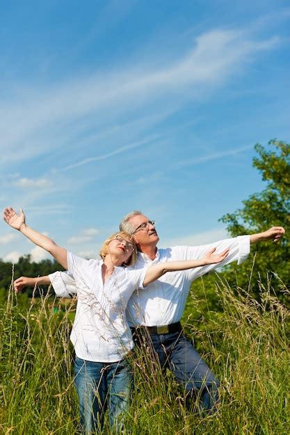 Premium Photo Mature Couple Having Fun In A Sunny Meadow