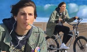 pierce brosnan s model son dylan smokes an e cigarette as he goes for a bicycle ride daily