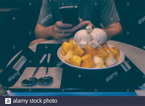 Man Is Taking Photo Of Mango Bingsoo Korean Shaved Ice Dessert With