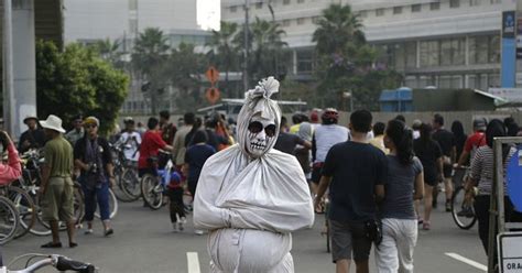 indonesians dress up as ghosts to scare people into