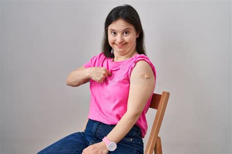 Woman With Down Syndrome Wearing Band Aid For Vaccine Injection