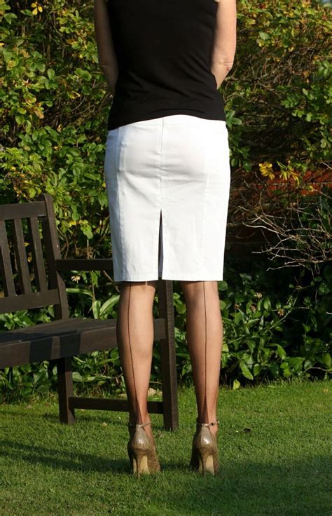 Visible Garter Bumps Under White Pencil Skirt Black Top Sheer Black