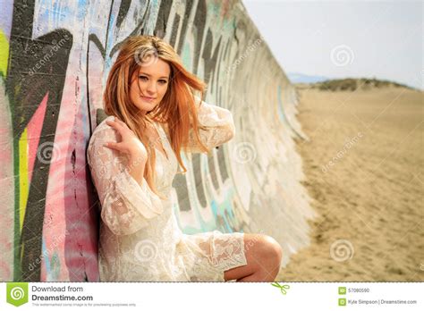 Teen Girl On A Graffiti Covered Wall At The Beach Stock