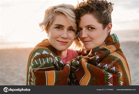Portrait Smiling Young Lesbian Couple Wrapped Together Warm Blanket
