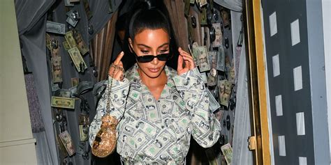 kim kardashian wore a money adorned trench coat and thigh high boots