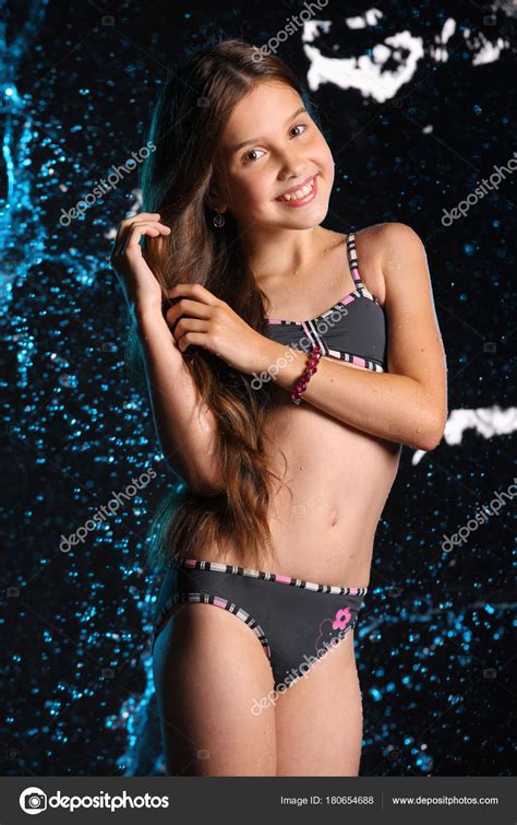 attractive happy young teenage girl posing dark bikini child long stock photo  cantonioclemens