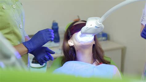 teeth whitening with ultraviolet lamp in dental clinic