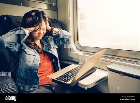 Asian College Girl Frustrated With Laptop On The Train Warm Light Tone