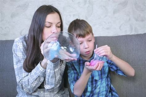 Mom And Son Inflate A Big Bubbles From A Slimes Play With Slime Stock