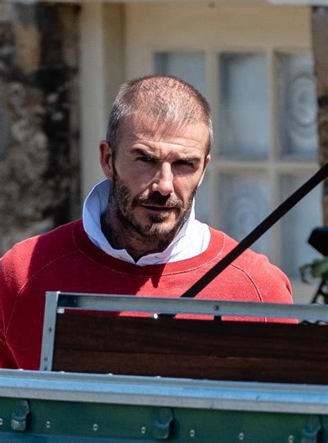 david beckham shows off shaved head and forgets to wear