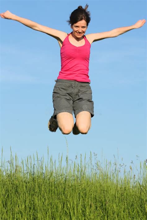 young woman jumping stock photo image  happiness active