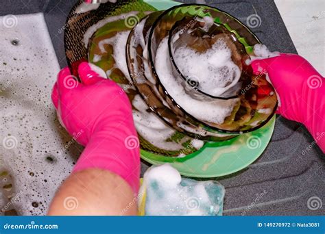 process  washing plates   sink hands  plates closeup