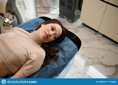 Overhead View Of A Caucasian Woman Lying On A Daybed Getting Ready For