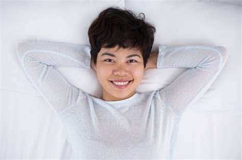 Free Photo Smiling Pretty Asian Woman Resting In Bed