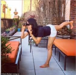 hilaria baldwin performs yoga pose on bathroom scale while wearing high