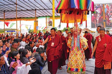 the 11th panchen lama surrounded by monks gives blessings to buddhist pilgrims on july 24 during