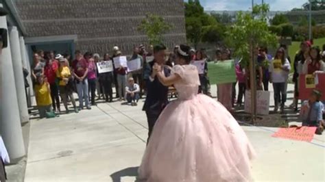 girl dances in quinceañera gown outside detention center where her