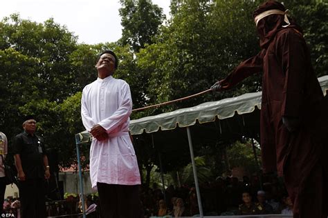 indonesian woman sobs as she is caned in public for having sex outside marriage daily mail online