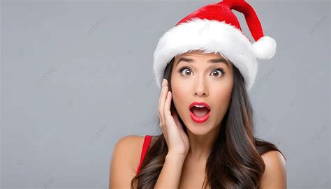 Shocked Christmas Woman Wearing A Santa Hat Isolated Over Gray