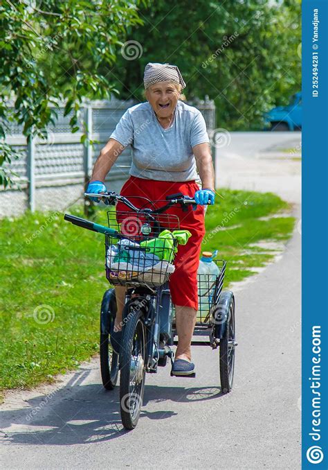 An Old Woman Rides A Bicycle Selection Focus Stock Image Image Of