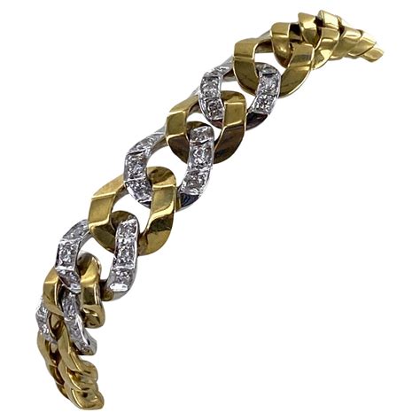vintage emerald and diamond tapered hinged cuff bracelet in 18 karat