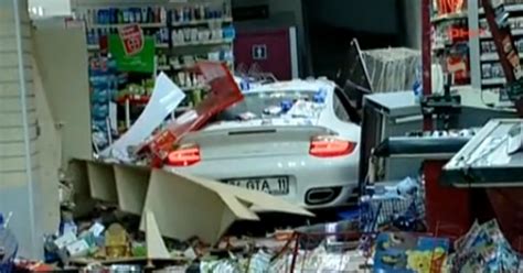 woman crashes porsche  turbo  gas station video