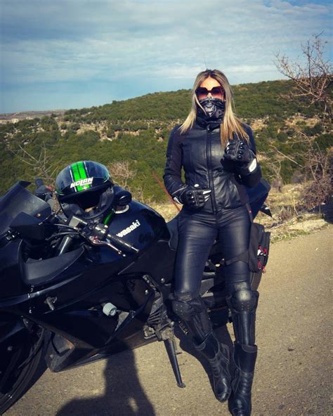 bandana masked and fully clad in leather biker girl motorbike girl