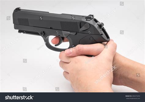 Hand Holding Black Gun Or Pistol On White Background Stock