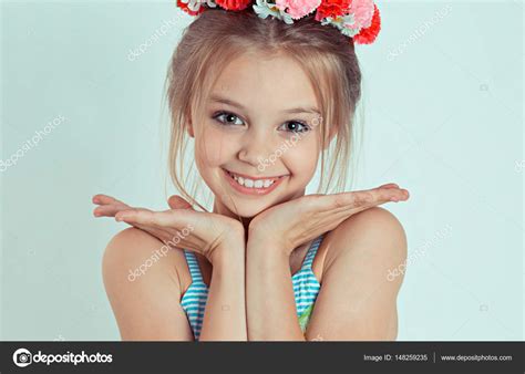 sweet smile close up cute happy teen girl standing with hands fingers near touching face and