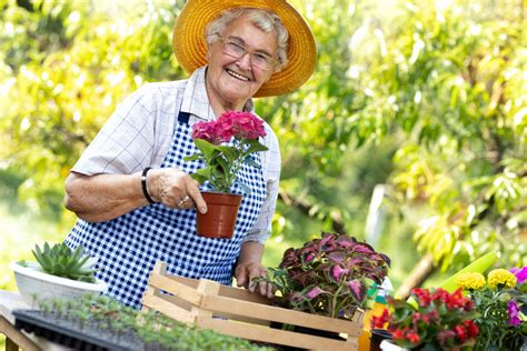 Download A Mature Woman Tending Her Lush Garden Wallpaper