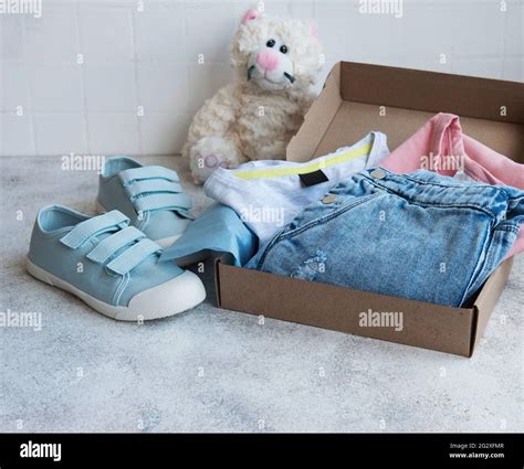 clothes  kids   open cardboard box  shopping concept