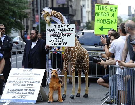 New York A Protestor Holds Signs Against Same Sex Marriage