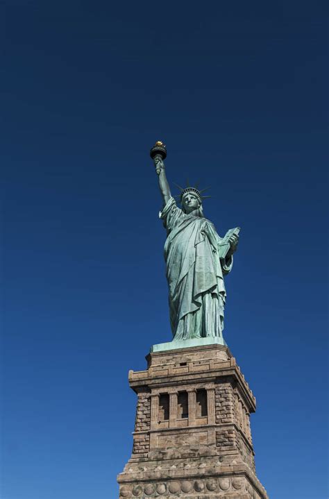 statue of liberty against clear blue sky stockfreedom