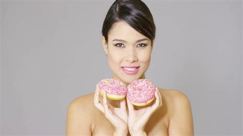 Single Gorgeous Hungry Woman With Bare Shoulders Eating A Donut Treat