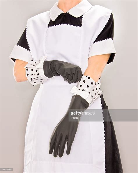 Maid Putting On Rubber Gloves Photo Getty Images