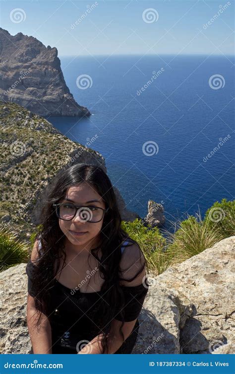 Latin Girl With Long Wavy Brown Hair On A Spring Day With Glasses In