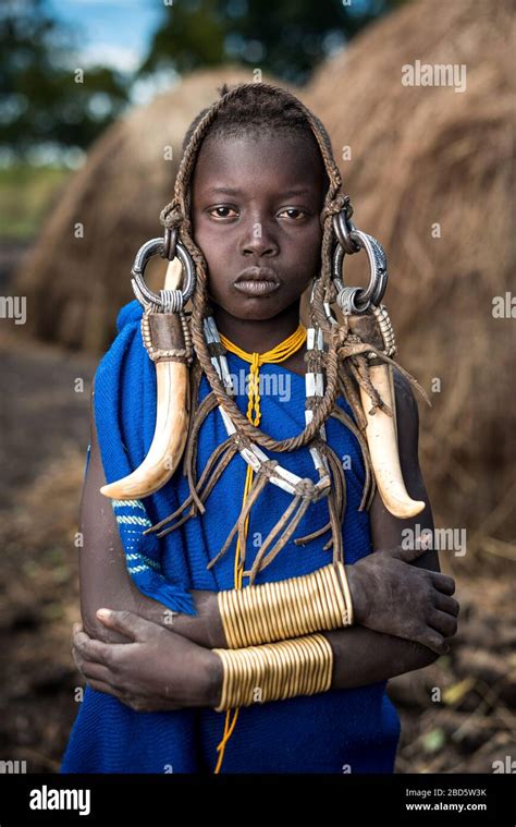 A Young Girl Adorns Herself With Cattle Horn Leather And Metal Jewelry